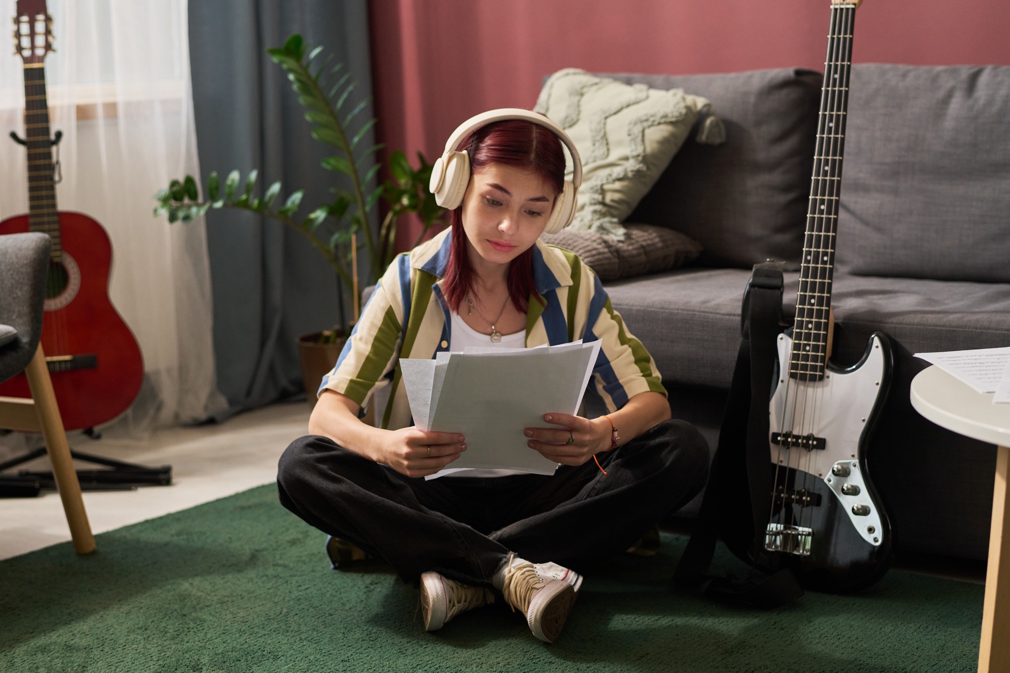 Teenage Girl Listening Headphones While Reading Documents